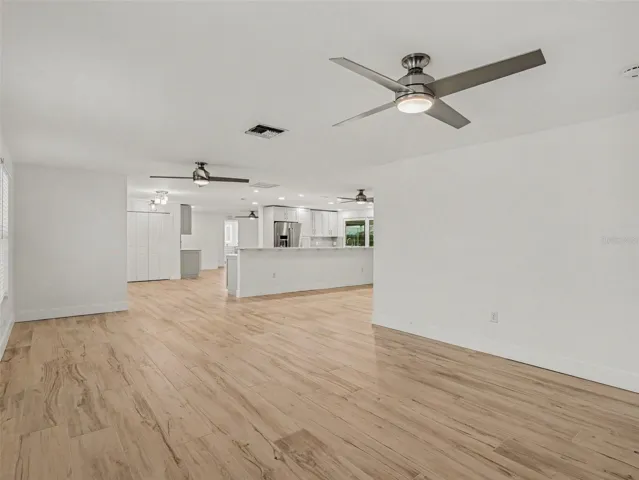 Living room looking into the foyer and kitchen