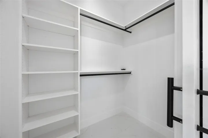 Walk in closet in primary bedroom