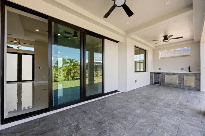 Covered lanai featuring outdoor kitchen