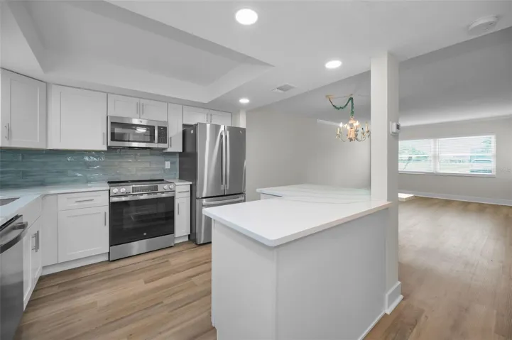 Renovated kitchen with wood cabinets, quartz counter tops and stainless steel appliances