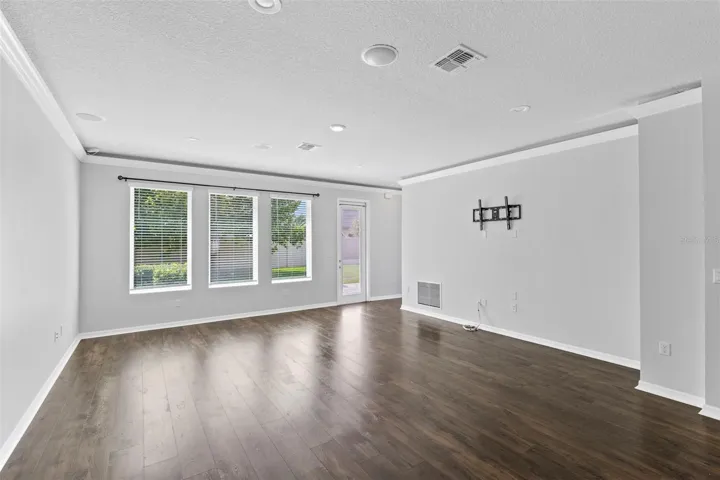 Family Room offers HUE lighting in crown molding, built in surround sound with included speakers.  Entertainment wall was built with added structure to hold very large TV.