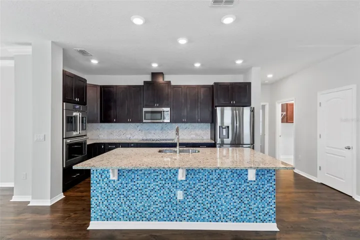 kitchen - Features new cabinets and tile backsplash with GE Cafe double wall oven, GE Cafe microwave vented, refrigerator, dishwasher