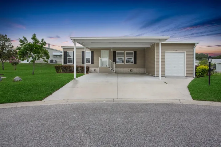 Front with DOUBLE carport and Golf Cart Garage