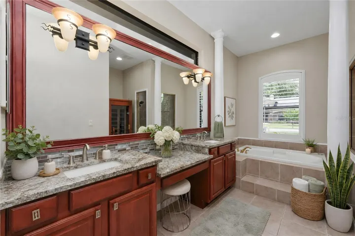 Primary Bathroom with quartz countertops, dual sinks and
