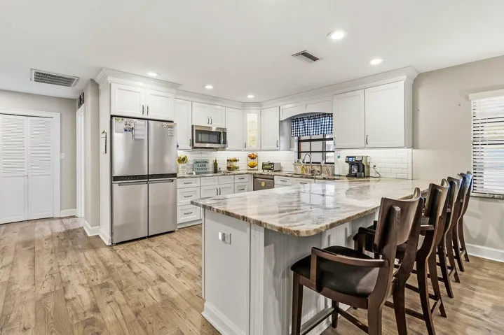Beautifully remodeled kitchen with wood cabinets and granite counters