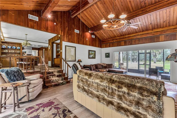 Living Room looking towards Screened in Front Porch and upstairs Dining Room