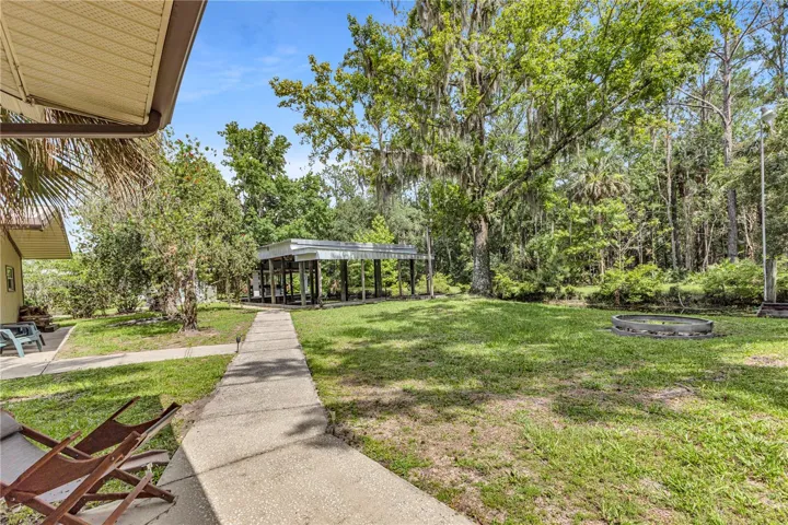 Sidewalk in back of home leading to garage and boat house