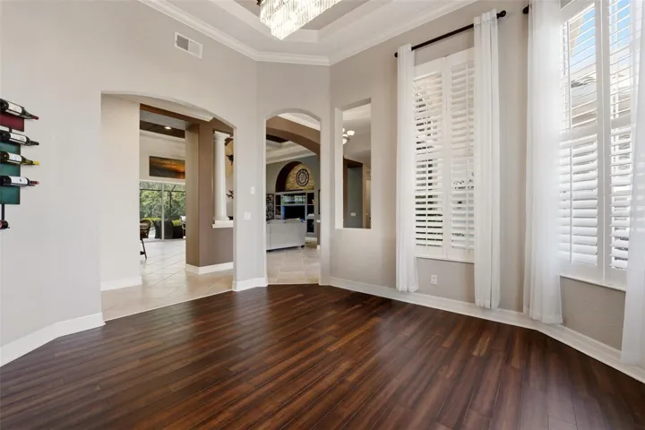 dining room with tray ceiling, crown molding and new hardwood flooring.