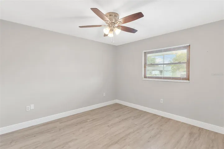 Primary Bedroom with Luxury Vinyl Wood Flooring