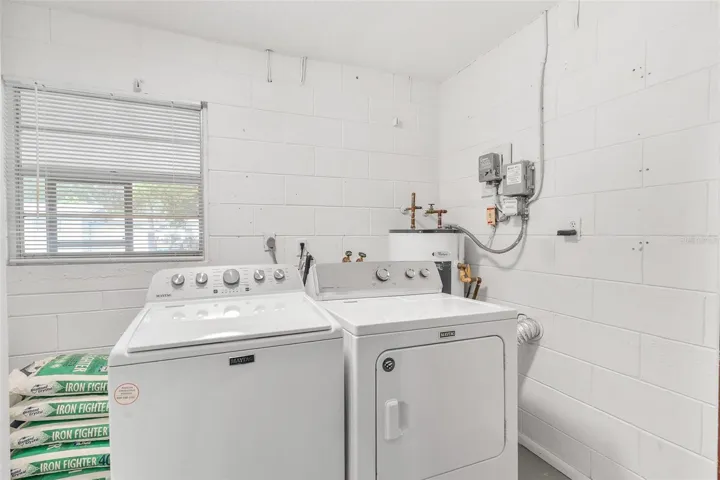 Dedicated Laundry Room in Garage with Durable Maytag Washer and Dryer