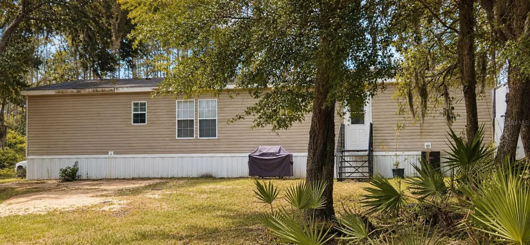 Backyard opens to expansive acreage and the beauty of Old Florida.