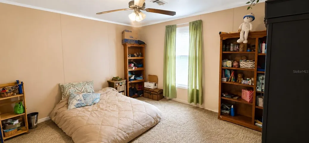 Comfortable guest bedroom with ample space and peaceful country views.