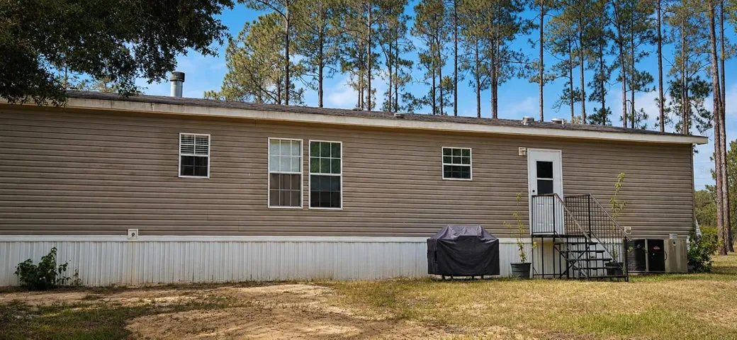 Wooded privacy surrounds this country retreat just minutes from Ocala.