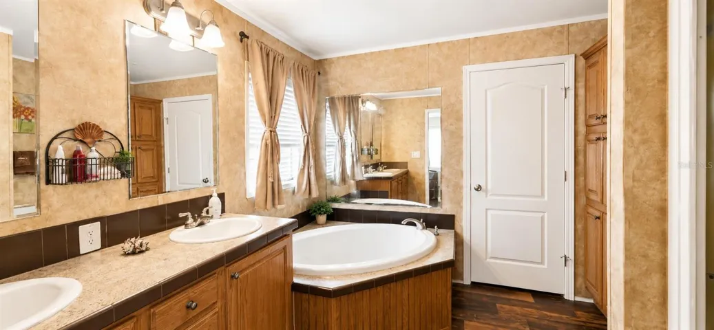 Large primary bathroom with dual sinks and abundant cabinet space