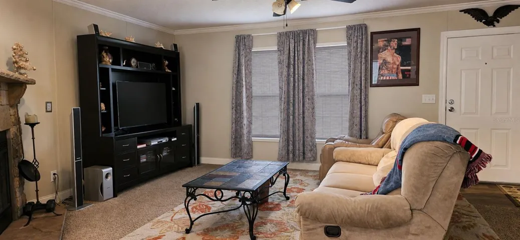 Warm and inviting living area centered around a beautiful stone fireplace.