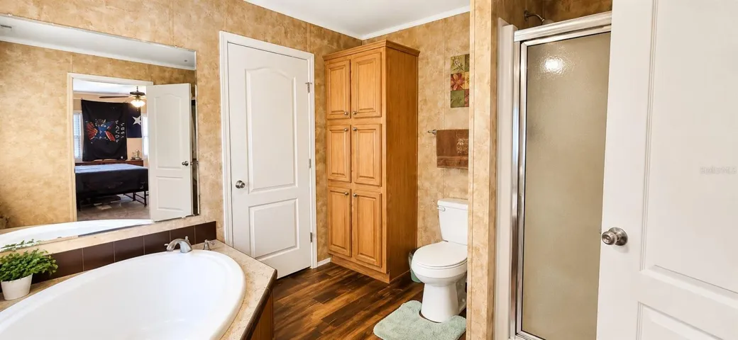 Primary bath featuring soaking tub, dual vanities, and generous storage.