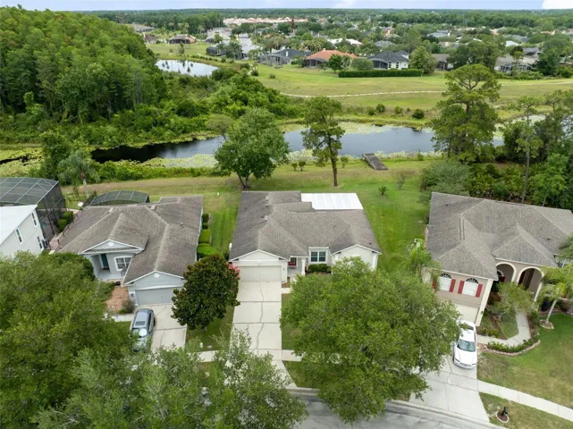 Major updates include NEW A/C (2025), ROOF (2019), PATIO RE-SCREENED (2026), EXTERIOR PAINTED (2019), DOUBLE PANE WINDOWS & SLIDERS, FRONT DOOR REPLACEMENT, and ENGINEERED WOOD FLOORING THROUGHOUT MOST OF THE HOME WITH NO CARPET. Additional features include outdoor plumbing, garage shelving and workbench, updated toilets, and more.