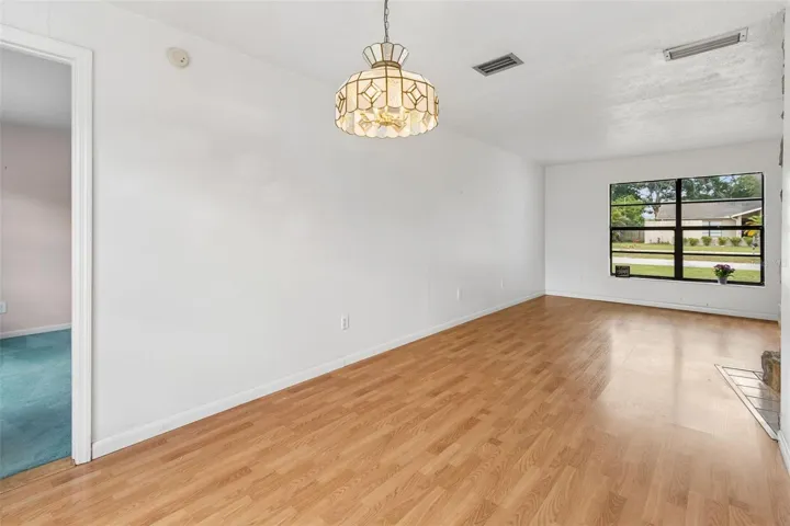 Living room with dining room combo featuring two extra large windows.