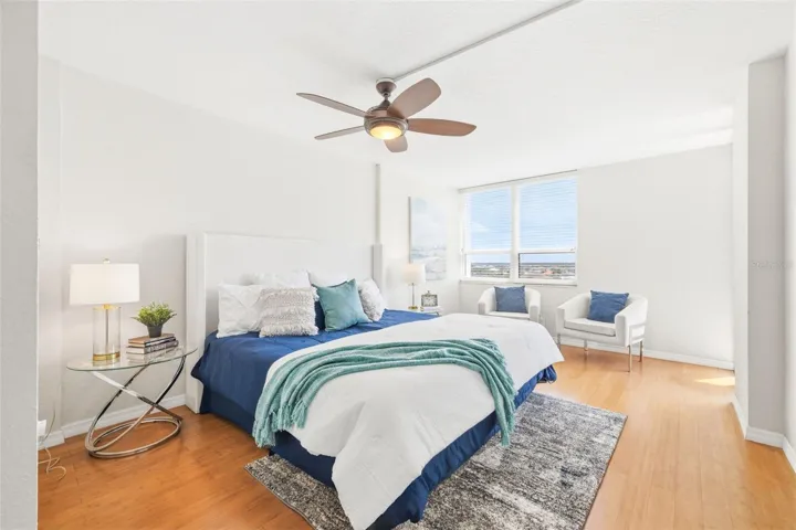 Primary bedroom with water view and balcony access