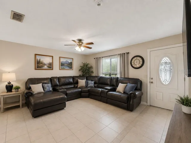 Virtually Staged LivingRoom_1018RedBayTer_PortCharlotte_NaturalLight_Entry.jpg