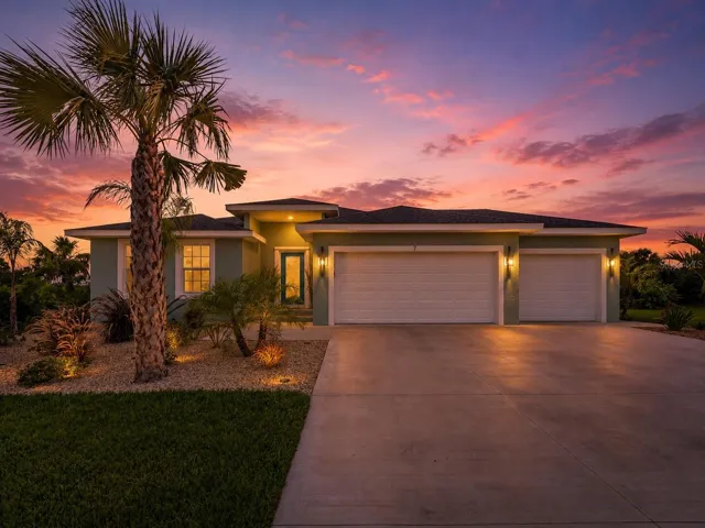 FrontExterior_7LeewardLane_Placida_TropicalLandscaping_Twilight.jpg
