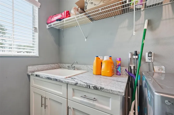 Granite countertops in the laundry room with sink.