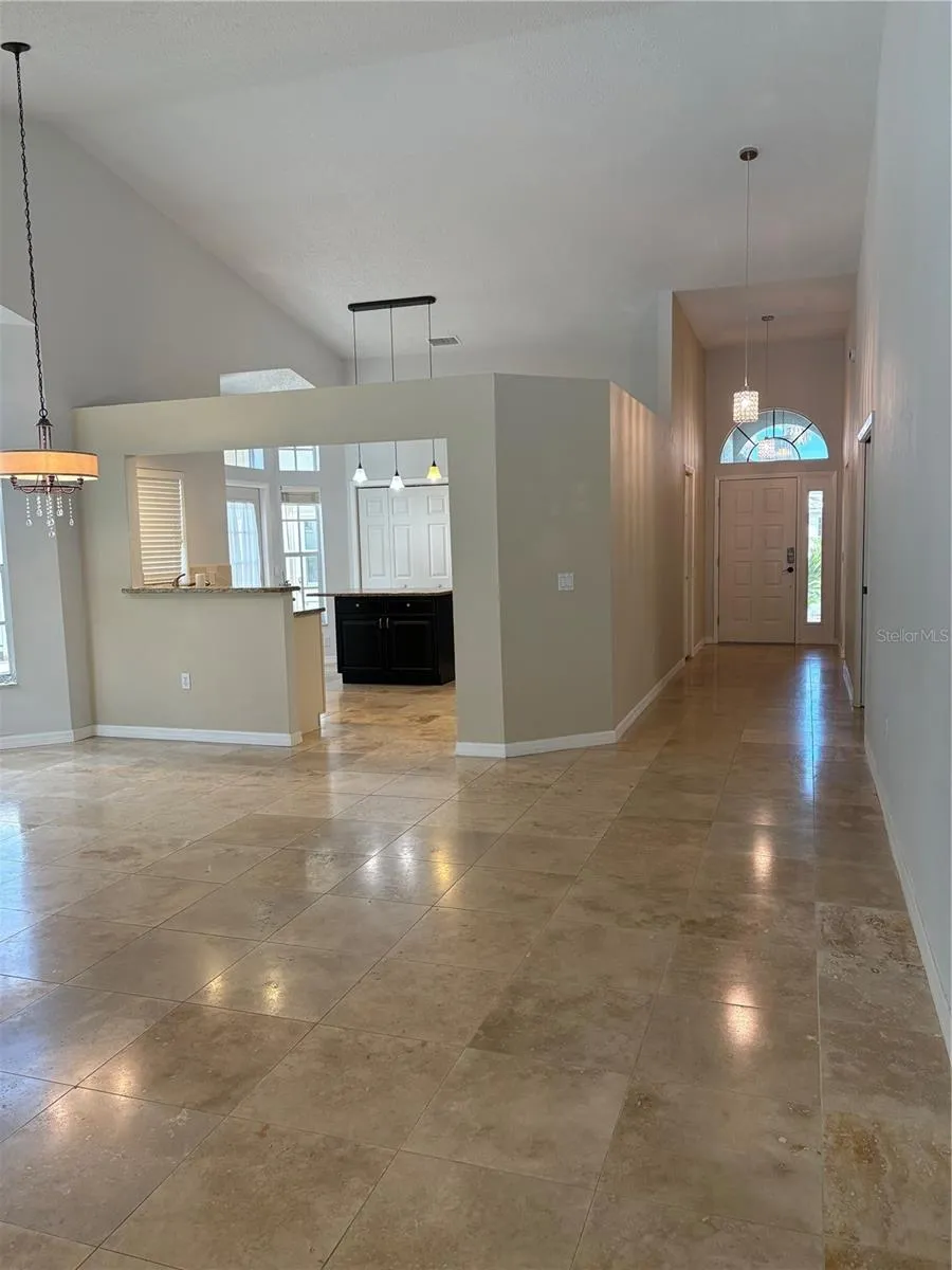 from living room looking onto dining, kitchen, hallway and entryway