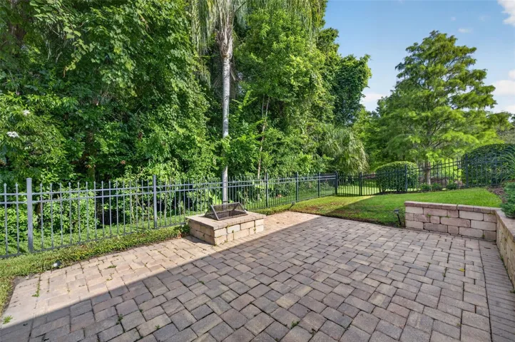 Paver patio with retaining wall, firepit and fence