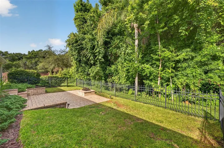 Paver patio with retaining wall, firepit and fence