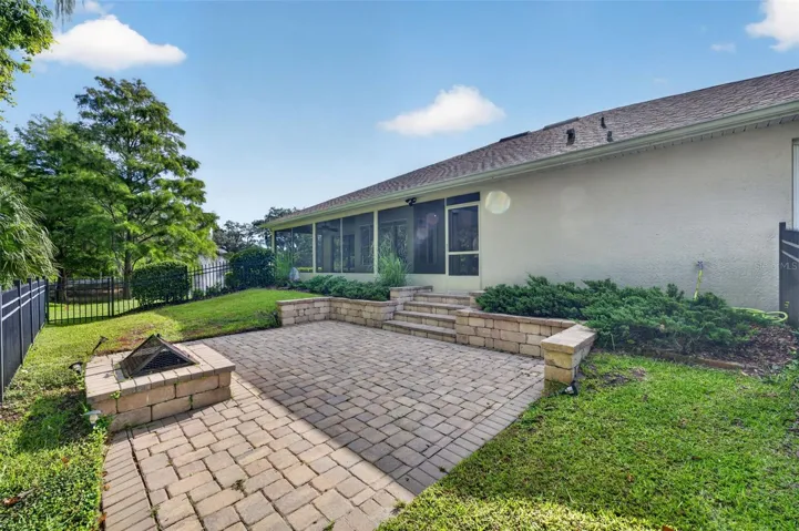 Paver patio with retaining wall, firepit and fence