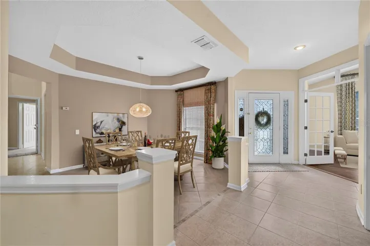 Virtually staged entrance with dining/living room views