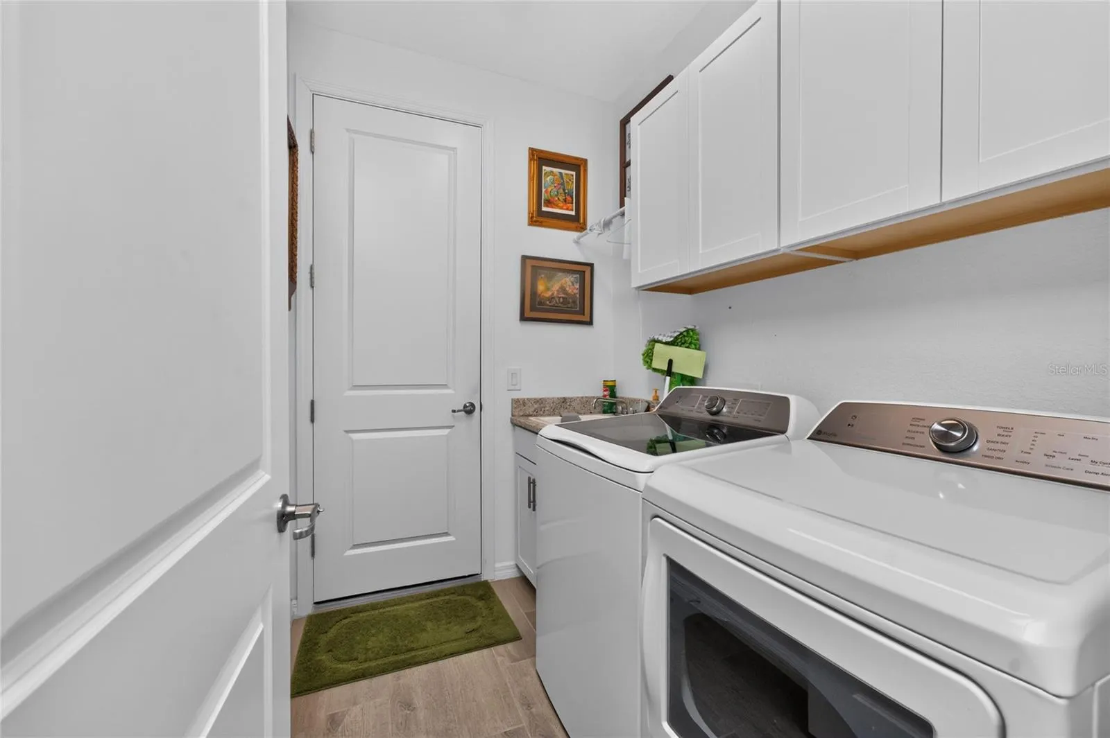 Laundry in side with sink and storage