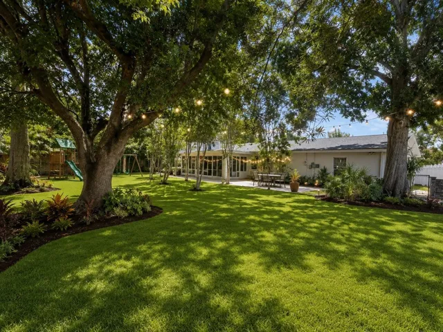 VIRTUALLY DESIGNED - View of back yard looking toward house.