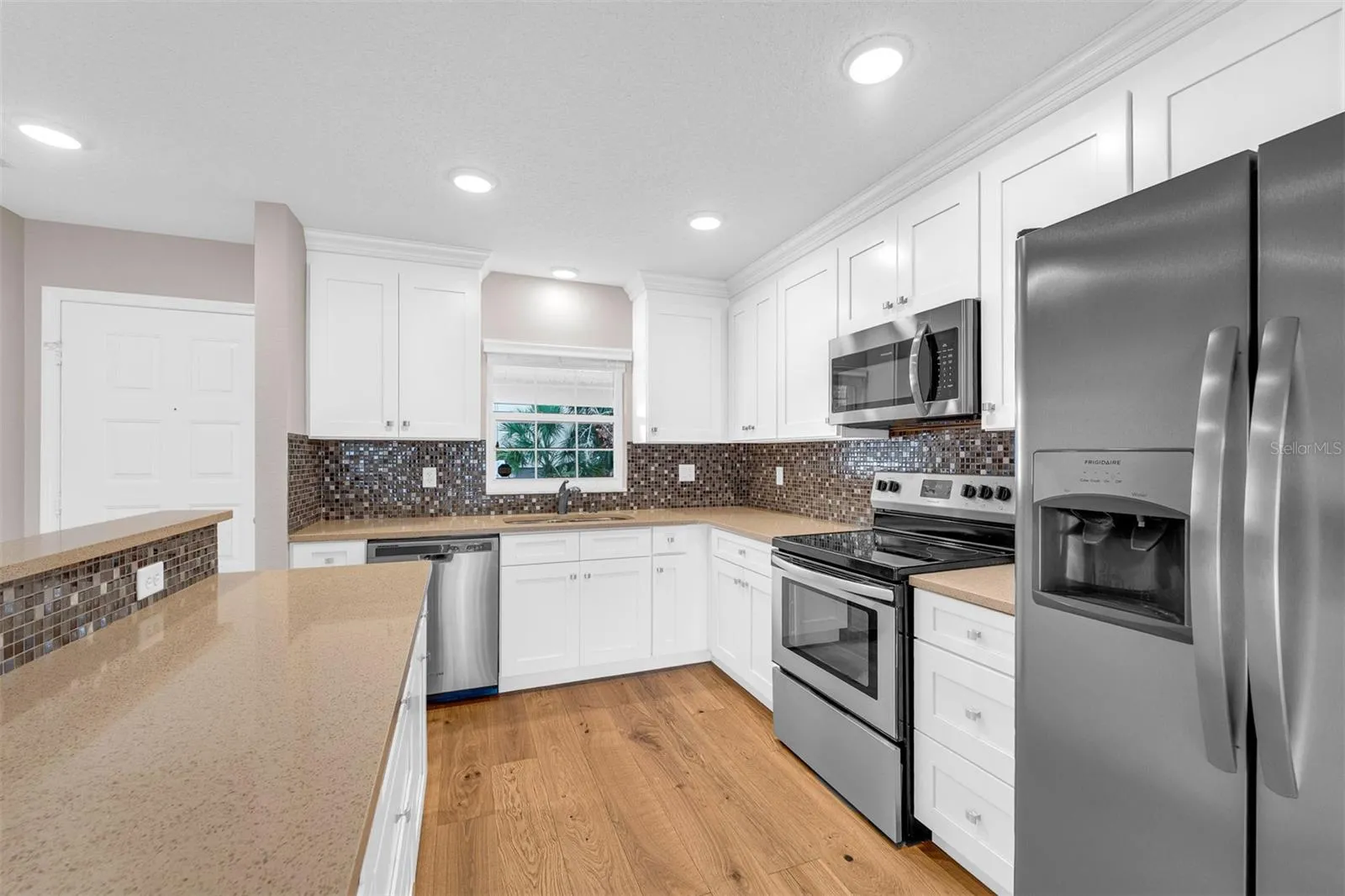 Window above kitchen sink allowing natural light to flow in