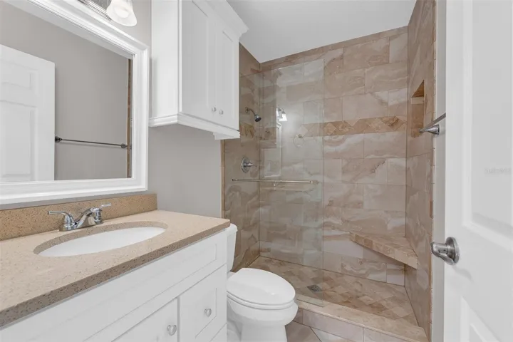 Guest bath with walk-in shower and beautiful travertine tile work