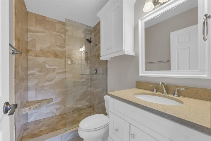 Primary ensuite bathroom with beautiful travertine tile.