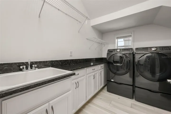 Laundry room with cabinets and sink
