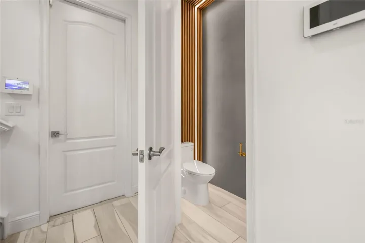 Downstairs half bath with door to garage