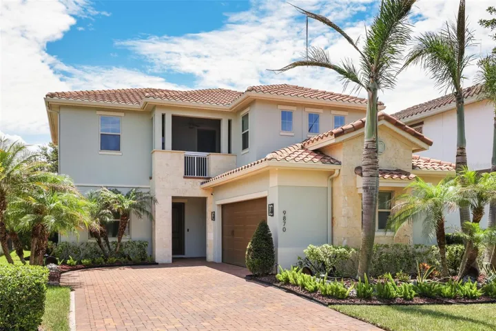 Beautiful exterior of 9870 Mere Parkway with large driveway and 2-car garage