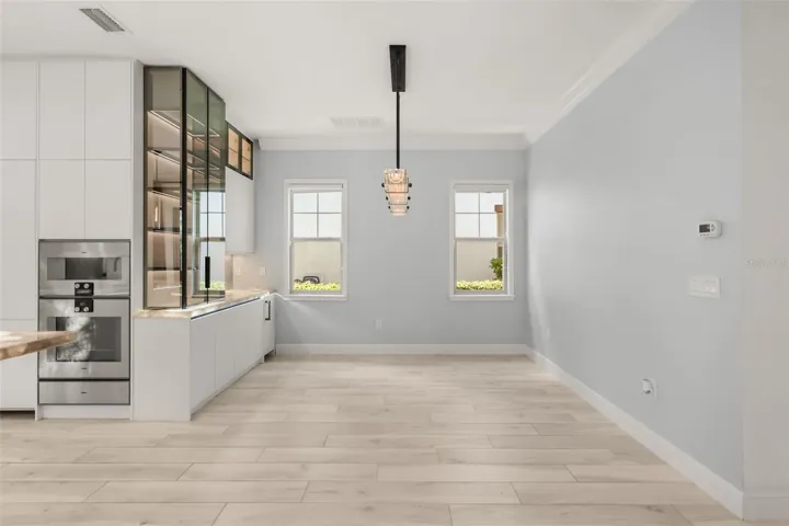 Dining room with custom Brazilian Backlit Cristallo quartzite countertops and built-in ice machine