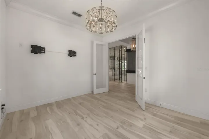 Flex room/Home office at front of home near foyer with Restoration Hardware chandalier