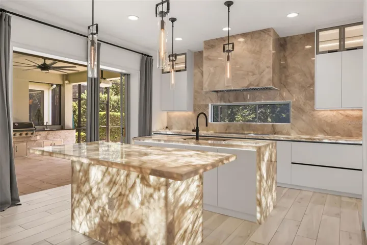 WOW! Luxurious backlit Brazilian Cristallo Quartzite countertops throughout the first floor!