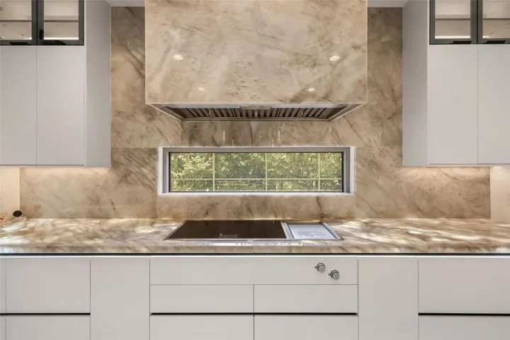 WOW! Luxurious backlit Brazilian Cristallo Quartzite countertops throughout the first floor!