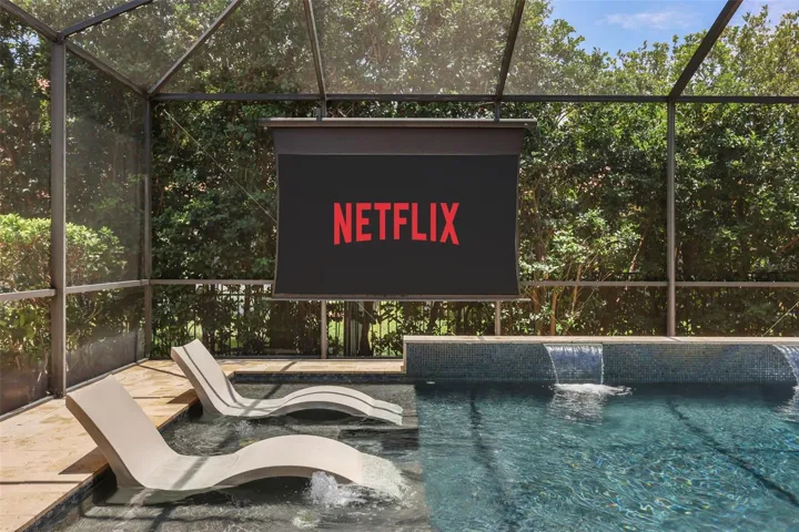 Automated screen with projector by the pool