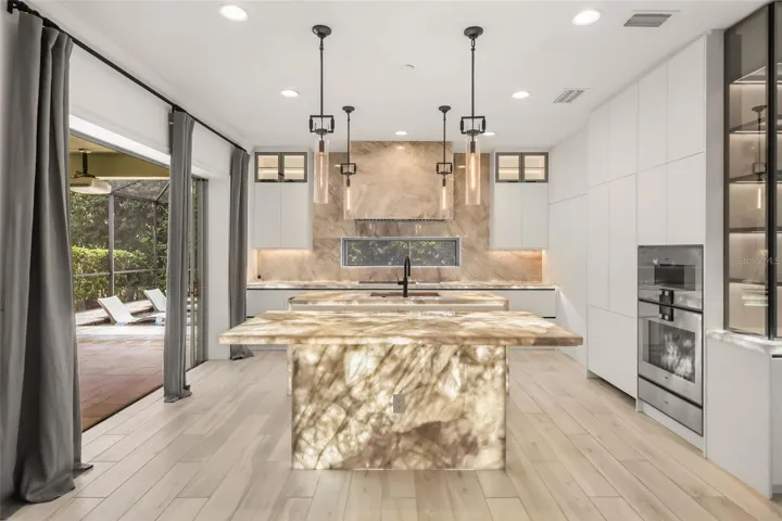 WOW! Luxurious backlit Brazilian Cristallo Quartzite countertops throughout the first floor!