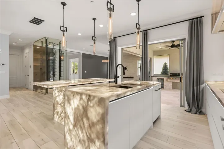 WOW! Luxurious backlit Brazilian Cristallo Quartzite countertops throughout the first floor!
