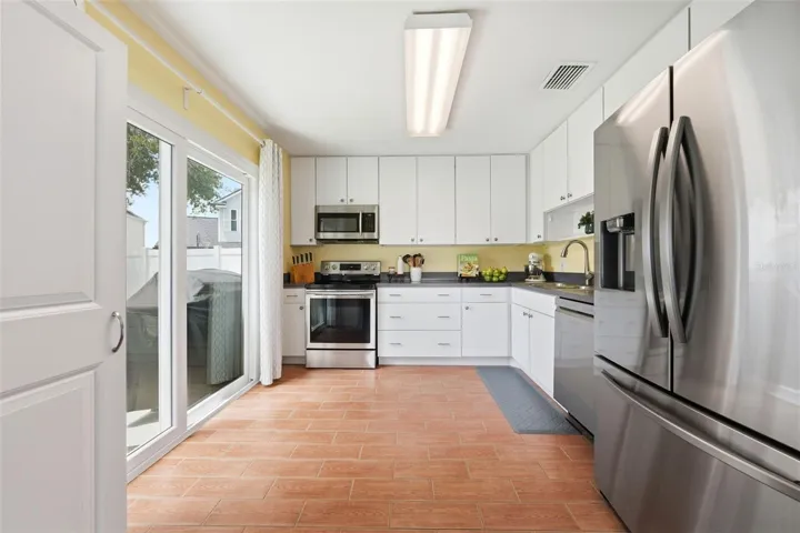 KITCHEN WITH SLIDERS TO COVERED PATIO