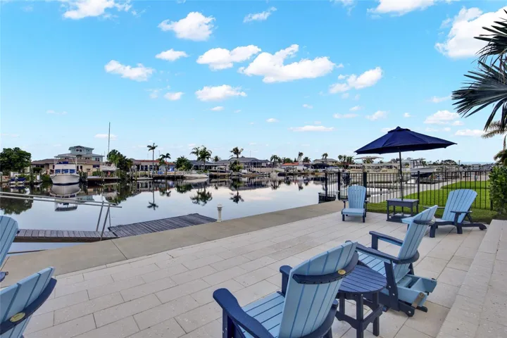 VIEW OF THE WATER FROM YOUR TROPICAL BACK YARD - PAVERS ARE MADE OF SHELLS AND DO NOT HEAT UP. EASY TO WALK ON.  NEVER HOT