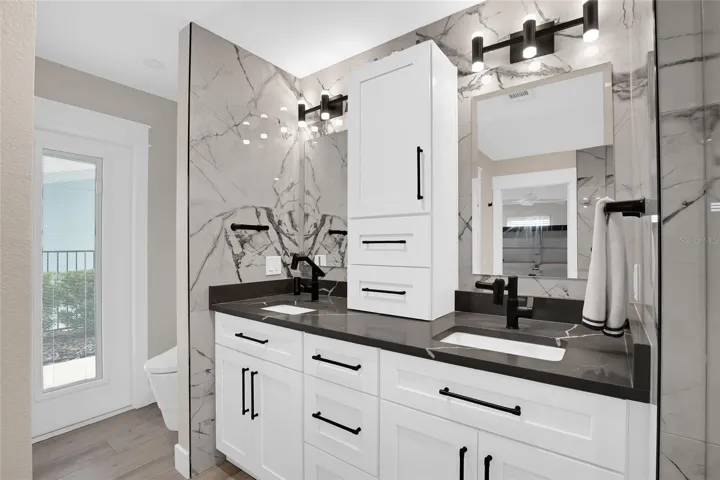 PRIMARY BATH - DOUBLE SINKS - ACCESS DOOR LEADS TO THE POOL.
