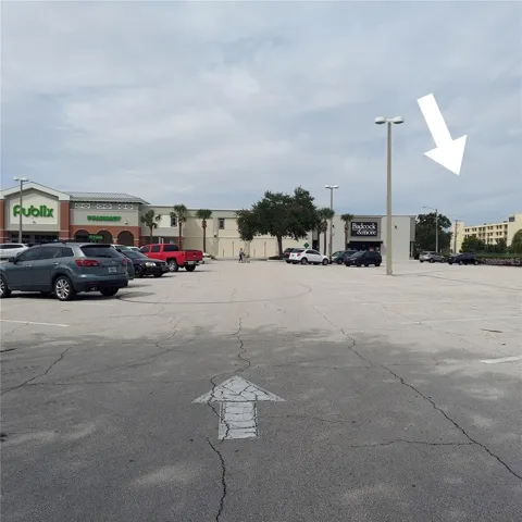 PUBLIX SHOPPING CENTER NEXT DOOR- WHITE ARROW IS CONDO BUILDING
